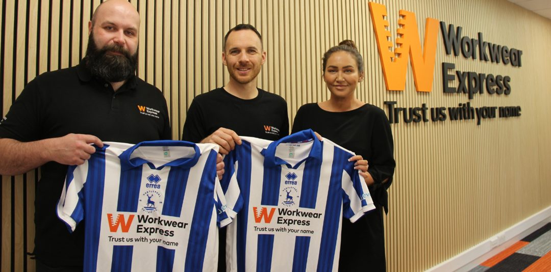 Workwear Express staff holding the sponsored Hartlepool United shirts at head office in Durham